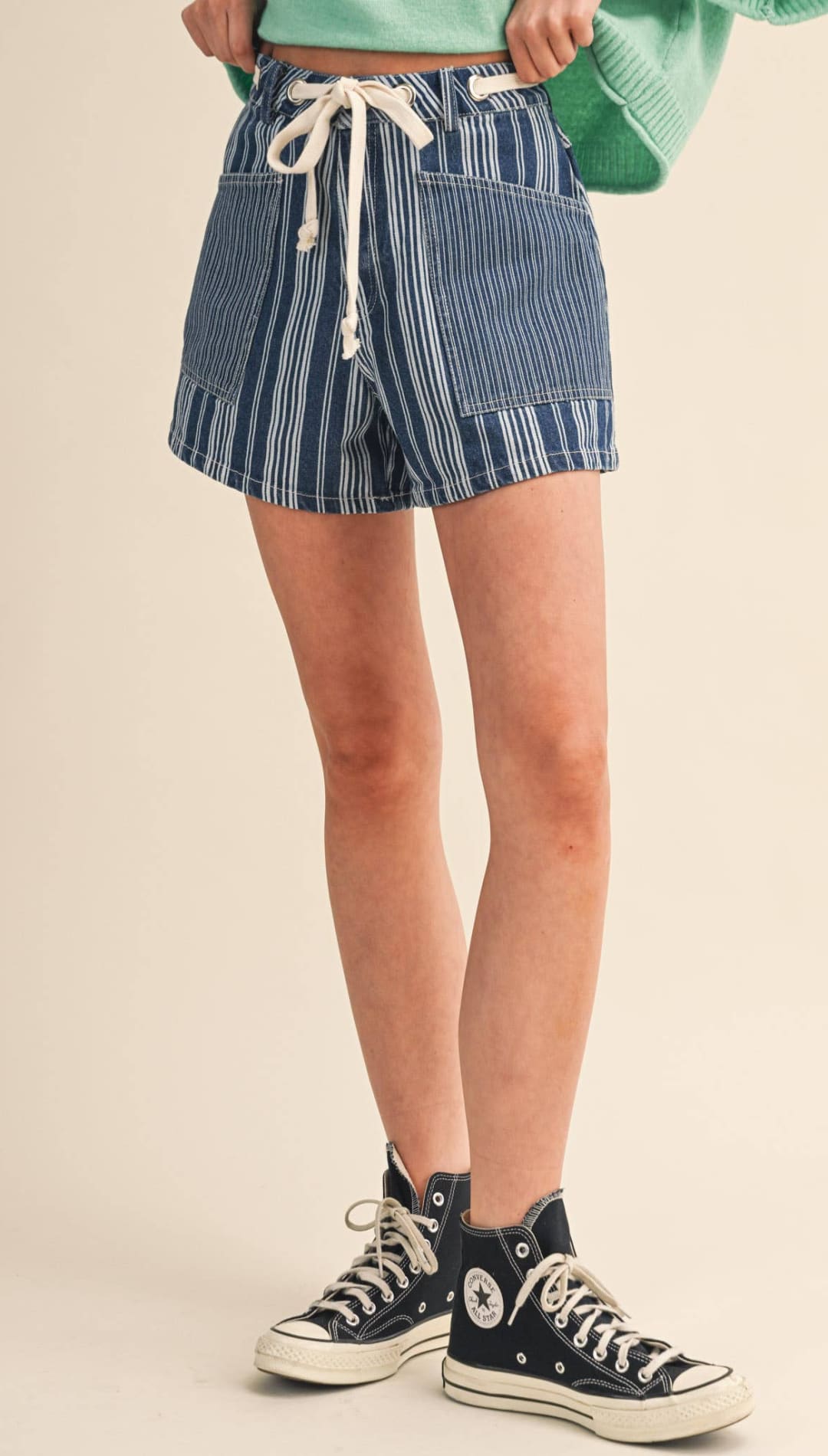 Blue and white vertically striped denim shorts with a drawstring waist.