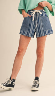 Blue and white vertically striped denim shorts with a drawstring waist.