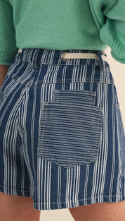 Blue and white vertically striped denim shorts with a light-colored belt loop.