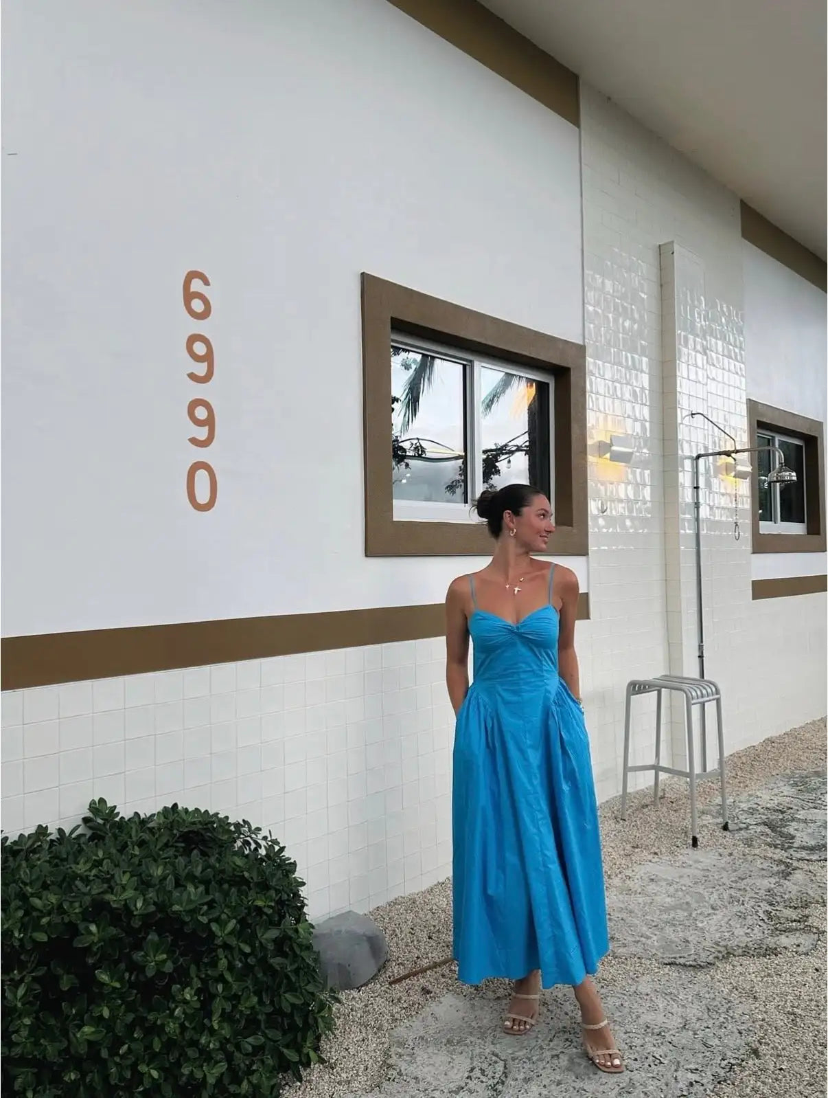 A vibrant blue, sleeveless maxi dress with a fitted bodice and flowing skirt.