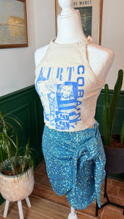 A shimmering blue sequined wrap skirt with a tie-side design.