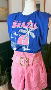 Blue sleeveless t-shirt with ’come to brazil’ graphic featuring a toucan and palm tree in pink, white, and blue.