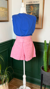 Pink high-waisted shorts with a belt loop and front pockets, displayed on a mannequin.