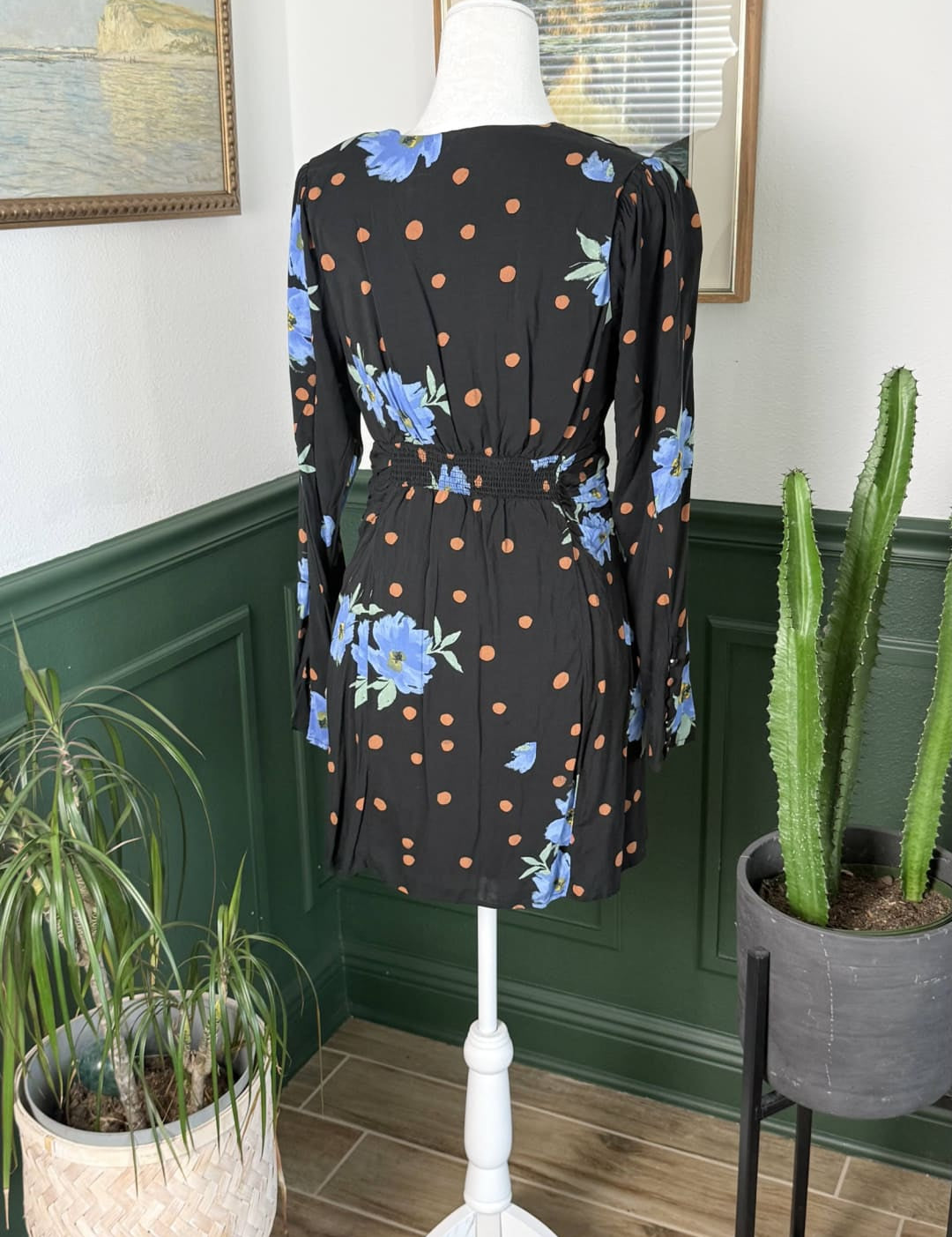 Black dress with blue floral and brown polka dot pattern, long sleeves, belted waist.