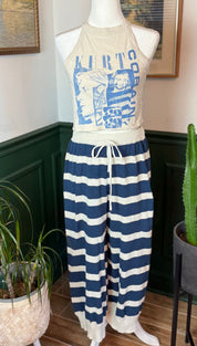Cream-colored halter top with blue graphic print featuring kirt cobain and striped pattern, paired with navy and white horizontally striped pants.