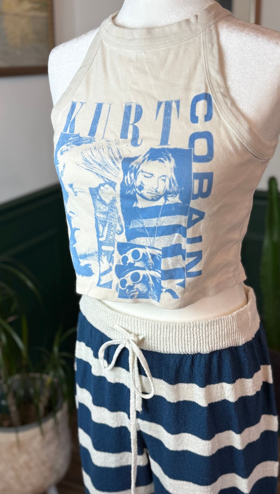 Beige halter top with blue graphic print of kurt cobain and the band name.