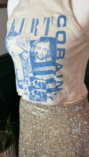 Cream-colored sleeveless tank top featuring a bold blue graphic print of kurt cobain with the name ’kurt cobain’ in matching lettering.