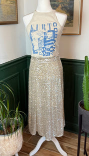 A shimmering gold sequin midi skirt displayed on a mannequin.