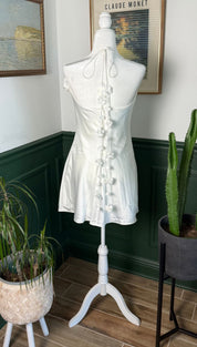 White satin dress with floral button closures down the back