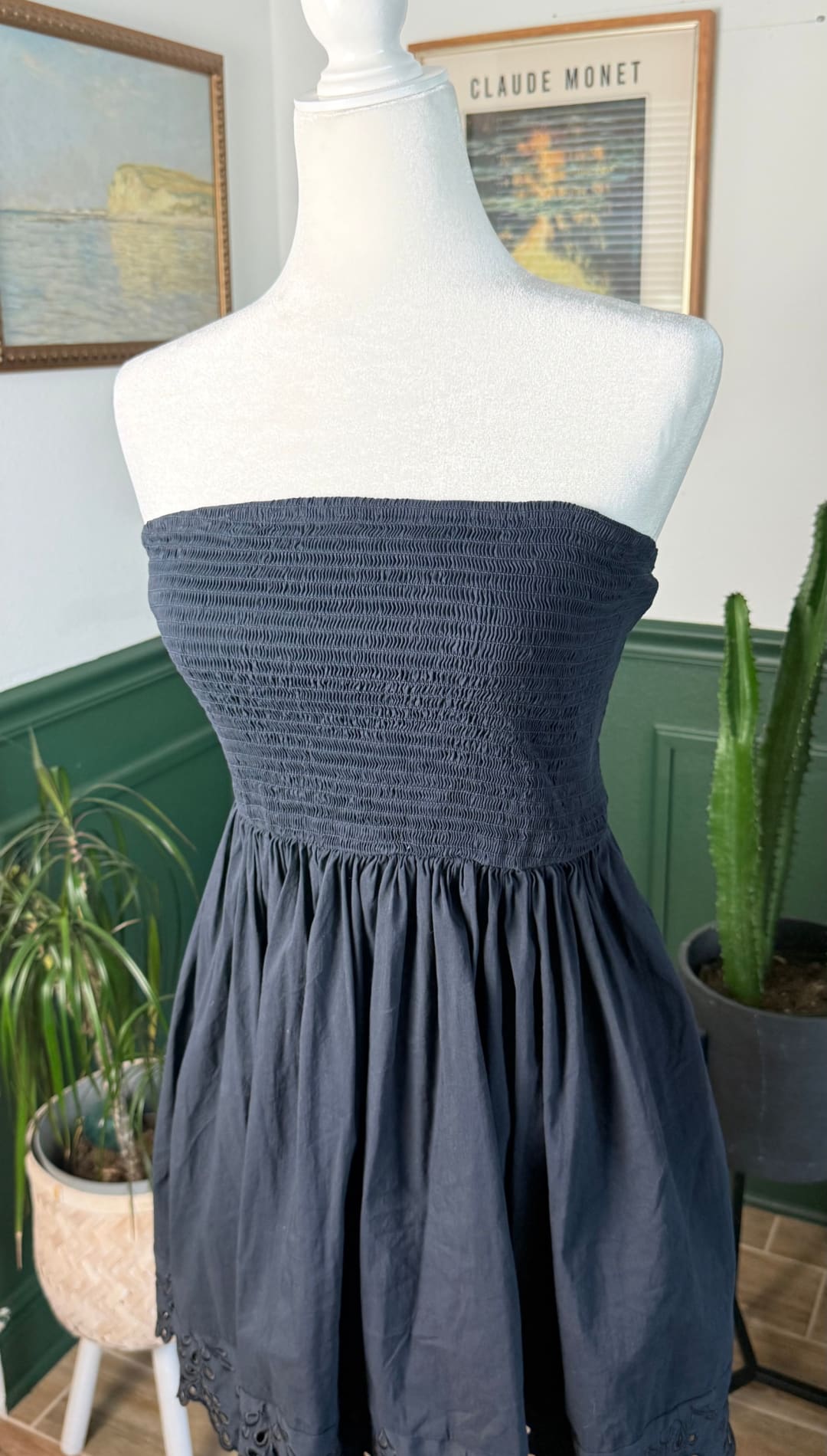 Navy blue strapless dress with smocked bodice and lace-trimmed hem
