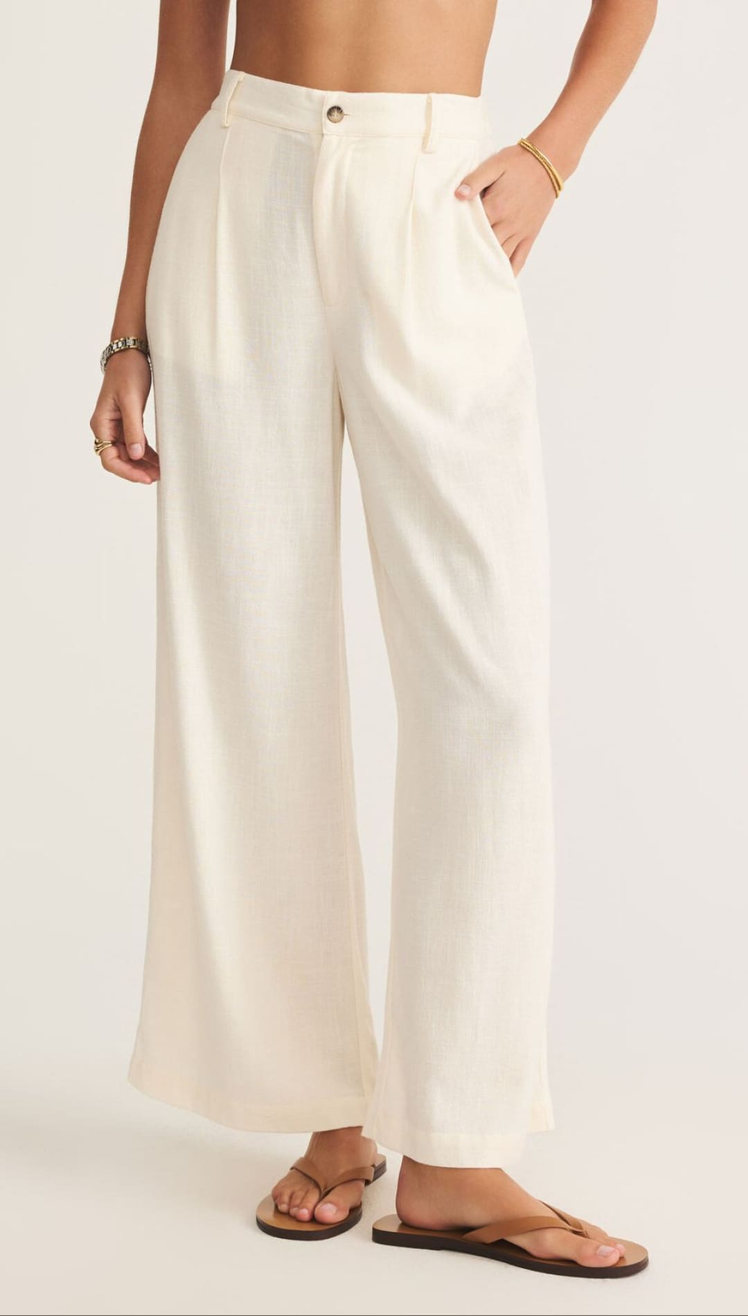 Cream-colored wide-leg pants.