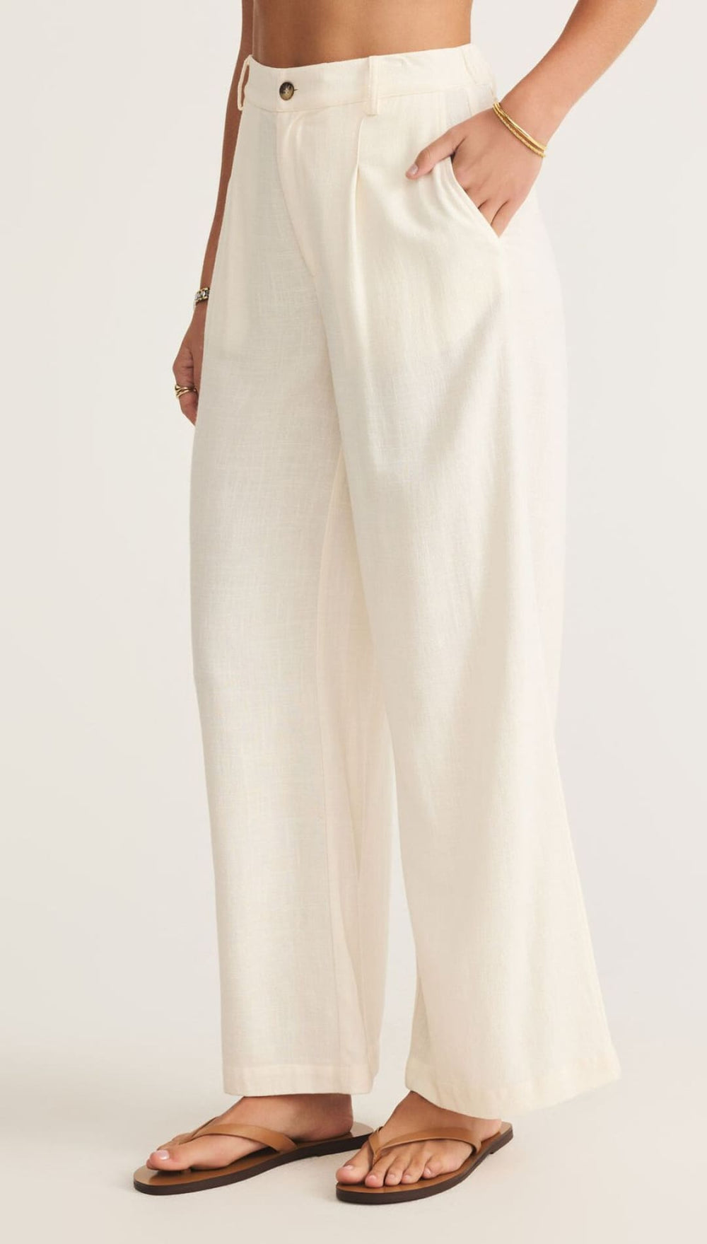 Cream-colored wide-leg pants.