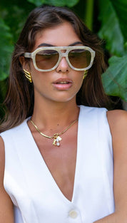 Cream-colored, geometric-framed sunglasses with brown lenses.