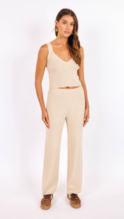 Cream-colored ribbed knit two-piece set featuring a cropped tank top and wide-leg pants.