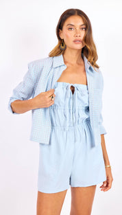 Light blue textured blazer with a subtle check pattern and buttoned cuffs.