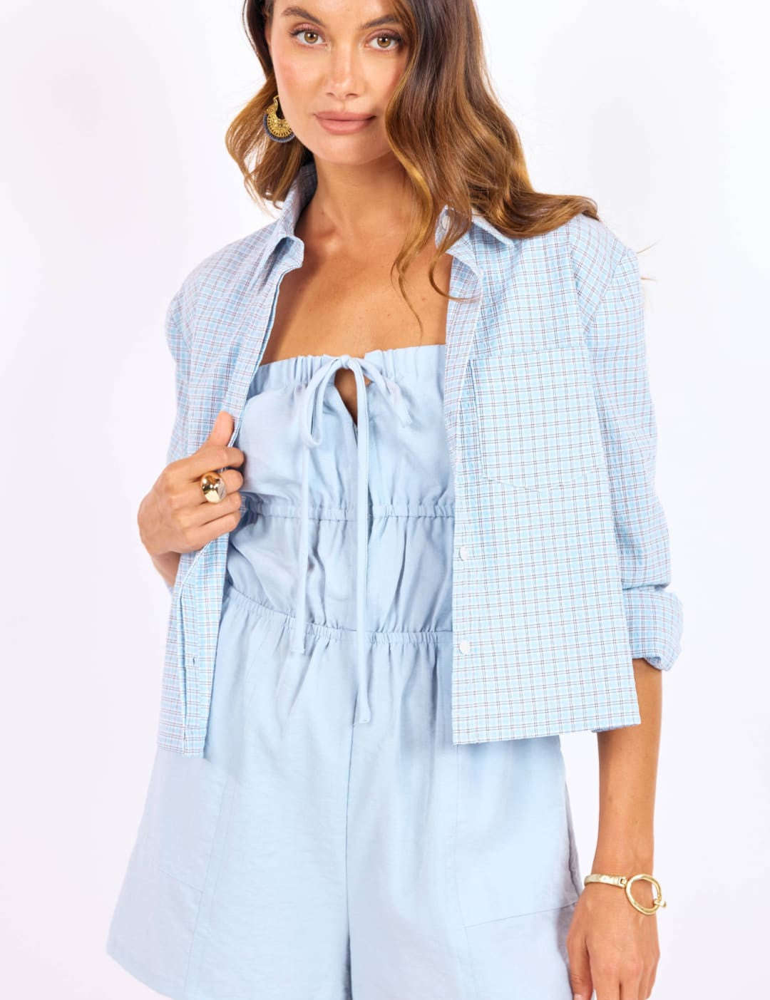 Light blue, textured fabric romper with a drawstring neckline and elastic waist.