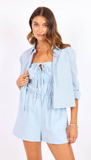 Light blue, textured fabric romper with a drawstring neckline and elastic waist.