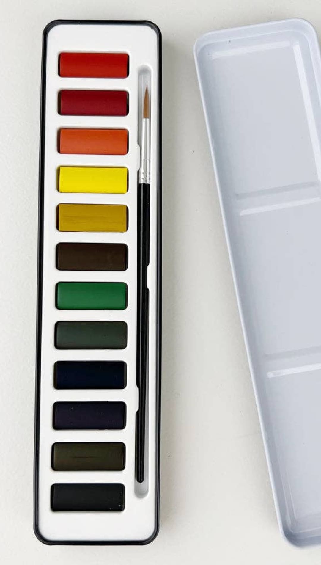 Watercolor paint set with 12 vibrant colors, brush included in black and white case.