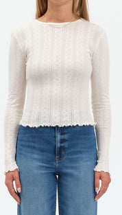 White scalloped lace cardigan sweater with long sleeves and ribbed texture.