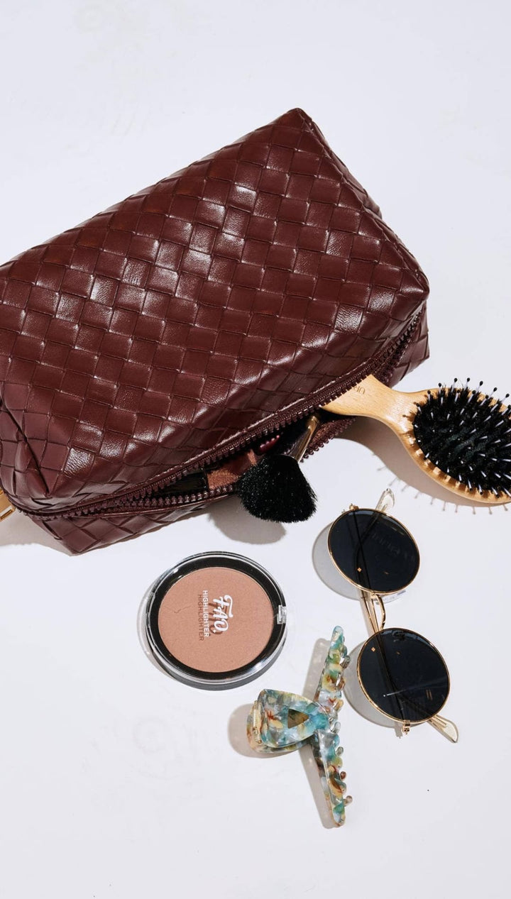 Brown woven leather pouch with zipper closure and quilted detailing.