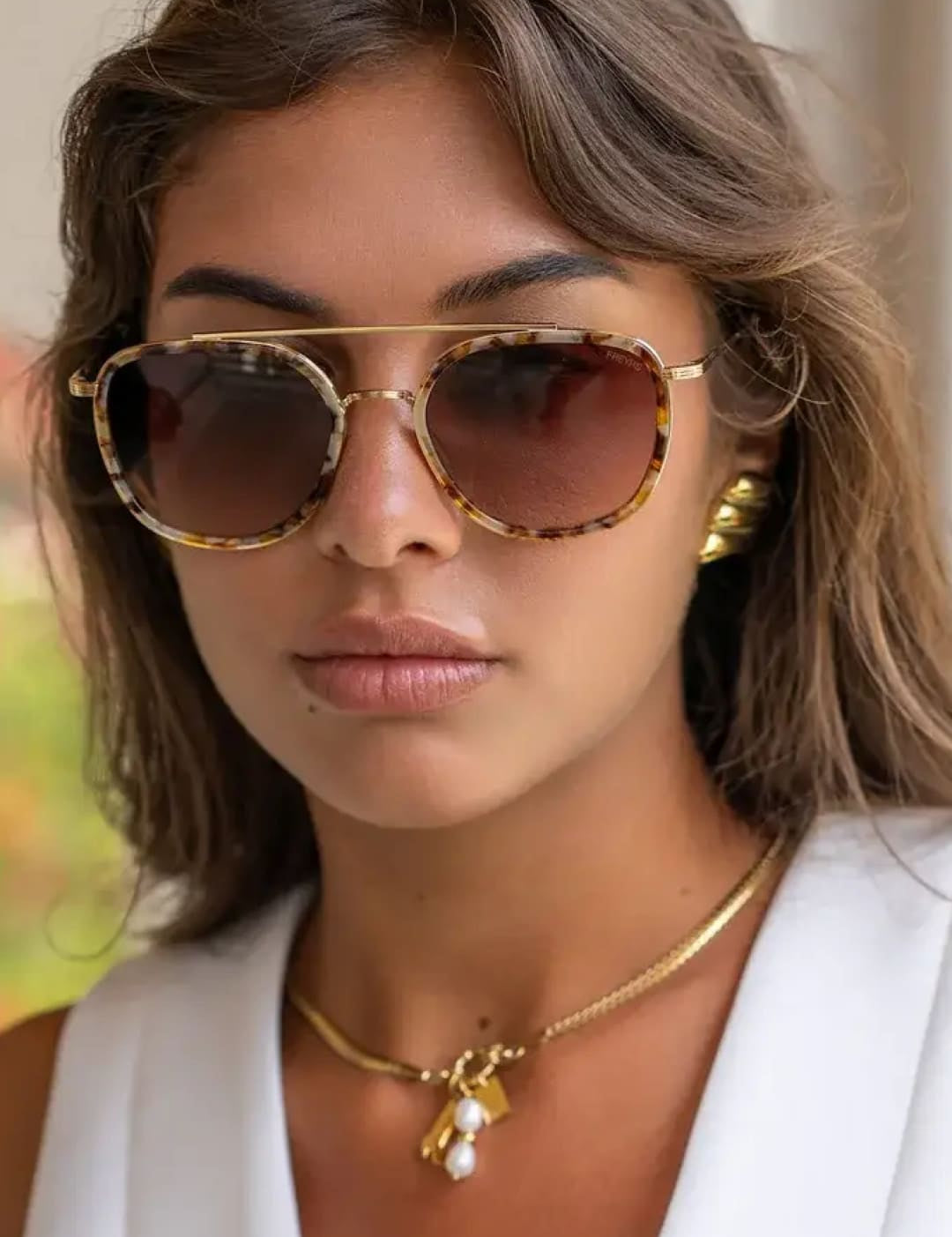 Tortoiseshell-patterned aviator sunglasses with gold metal frames and gradient brown lenses.