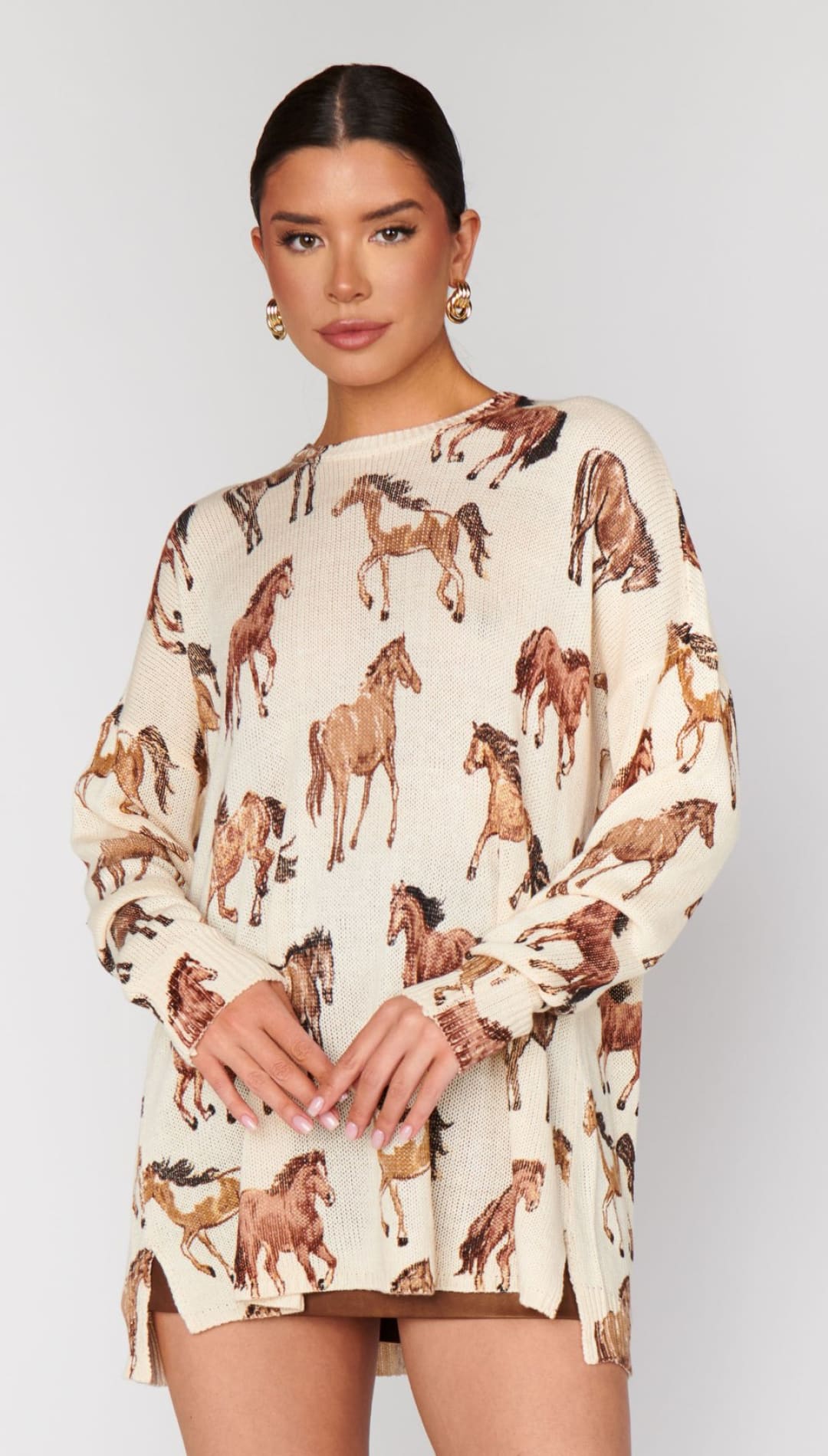 Off-white long-sleeve tunic sweater with brown horse print.