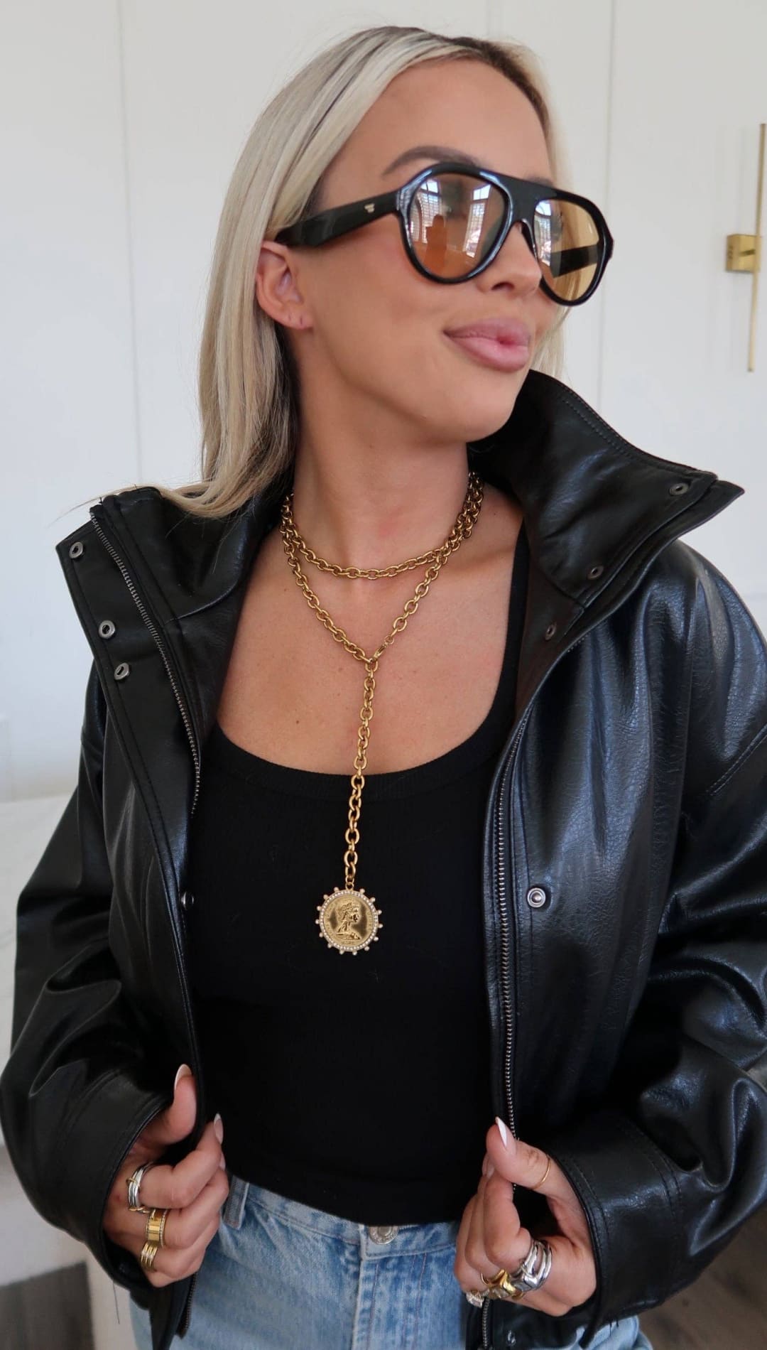 Gold chain necklace with a circular medallion pendant