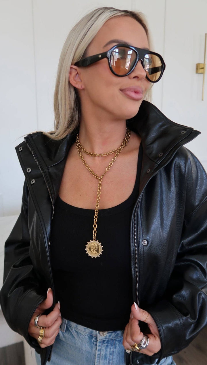 Gold chain necklace with a circular medallion pendant