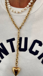 Gold-toned chain necklace with a polished heart-shaped pendant.