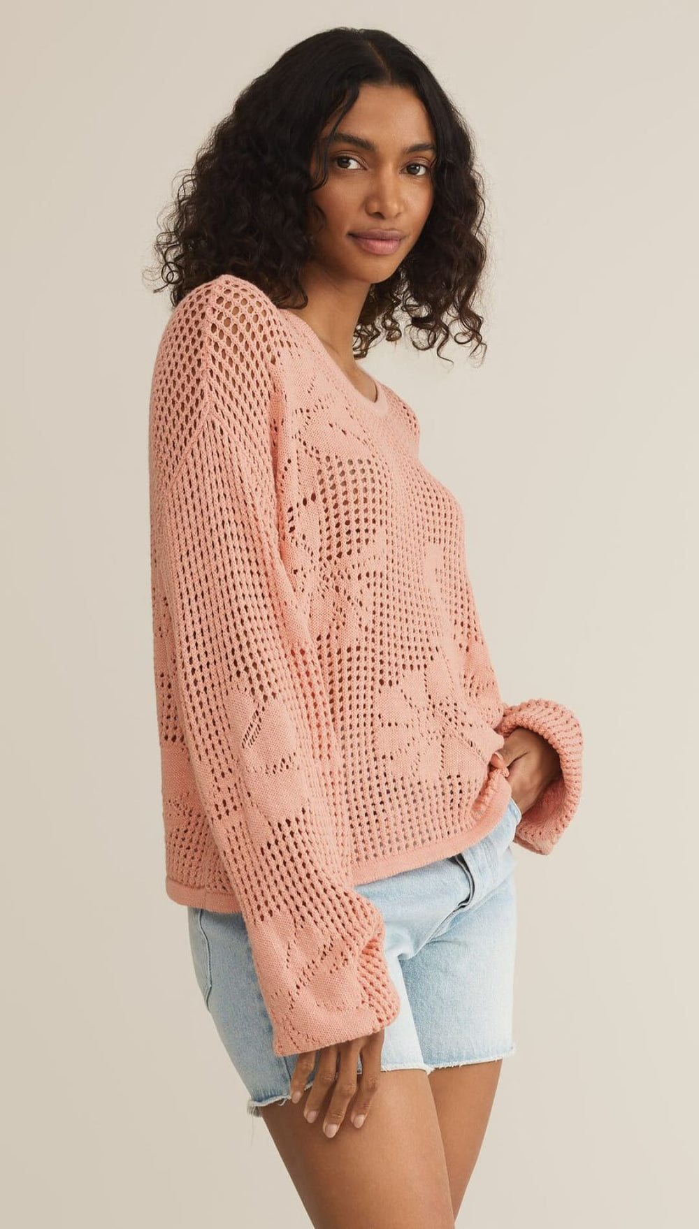 Pink open-knit sweater.