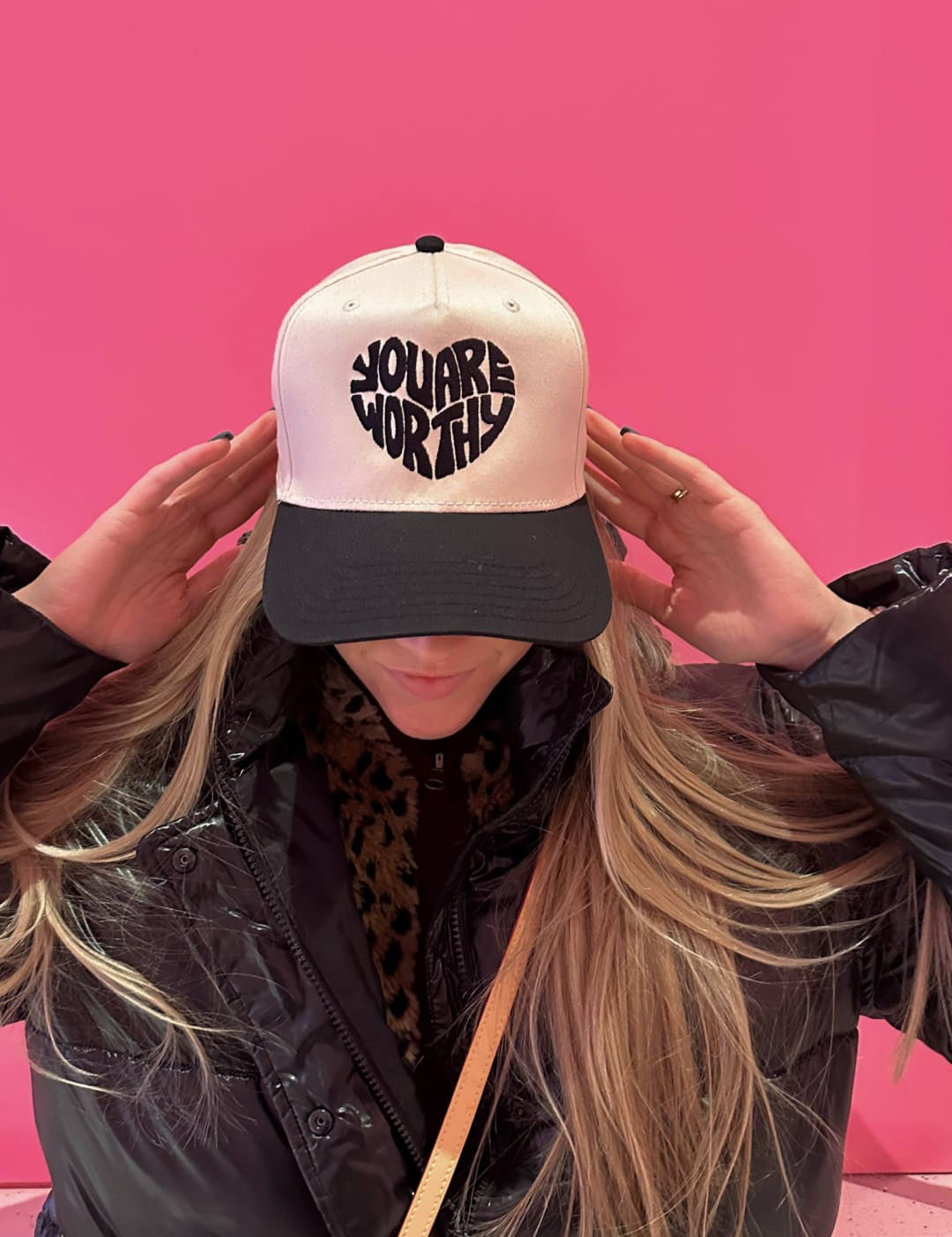 Black and white baseball cap with heart design, louis vuitton crossbody bag.