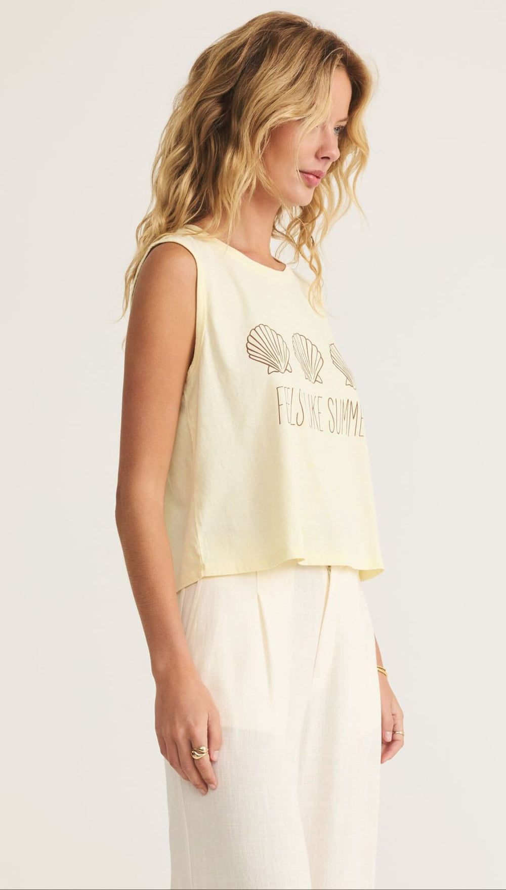 Woman’s yellow sleeveless top.