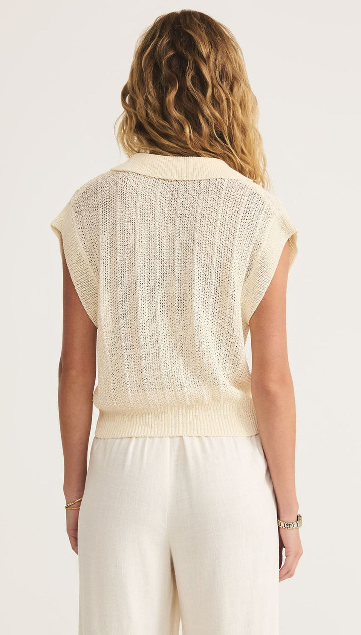 Woman’s cream-colored knit vest.