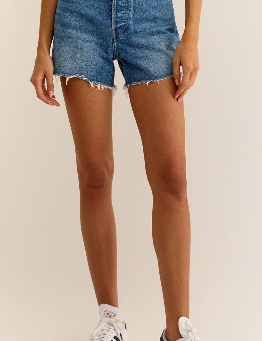 High-waisted denim shorts with frayed hem.