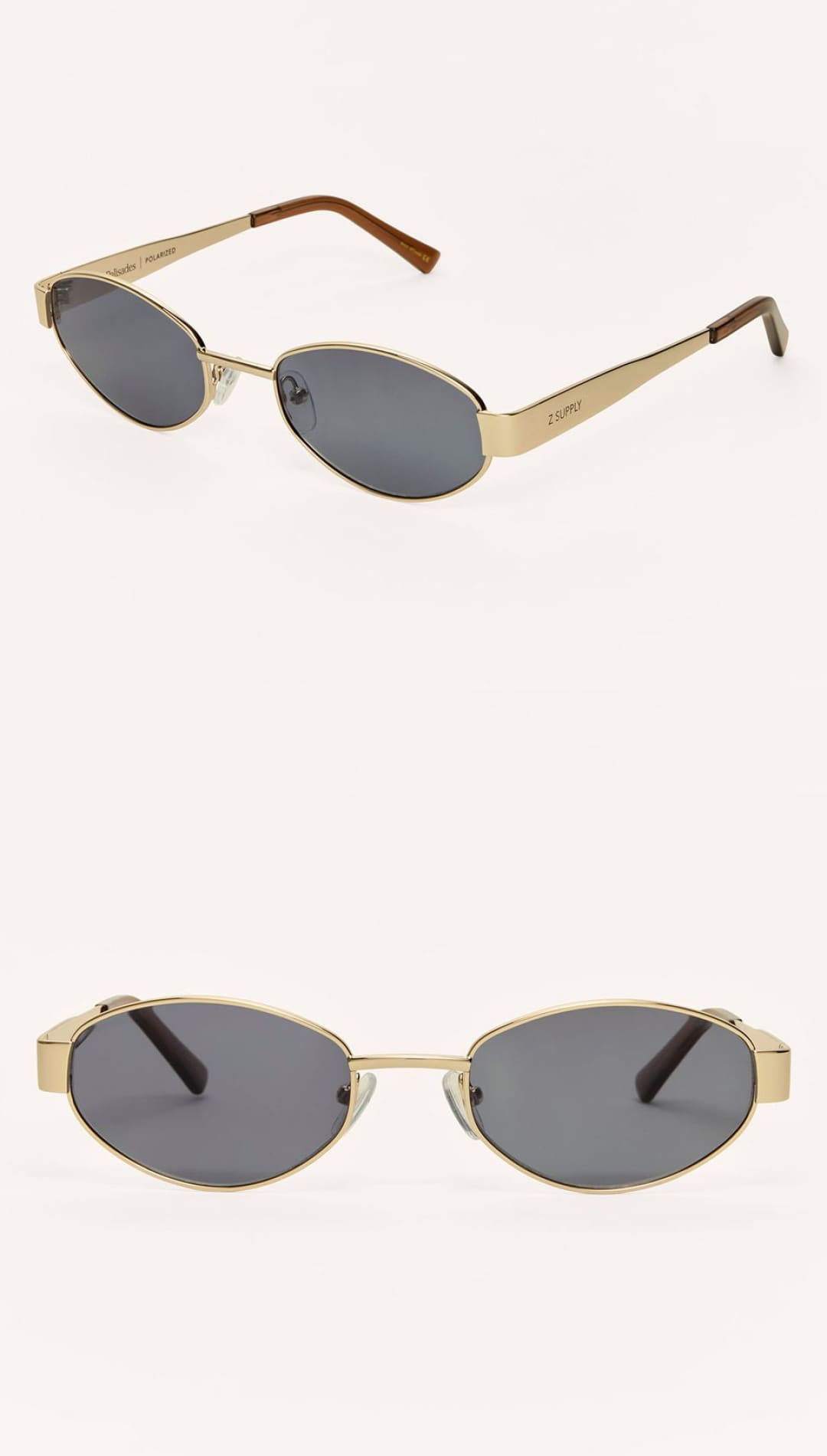 Gold-framed oval sunglasses with dark gray lenses.