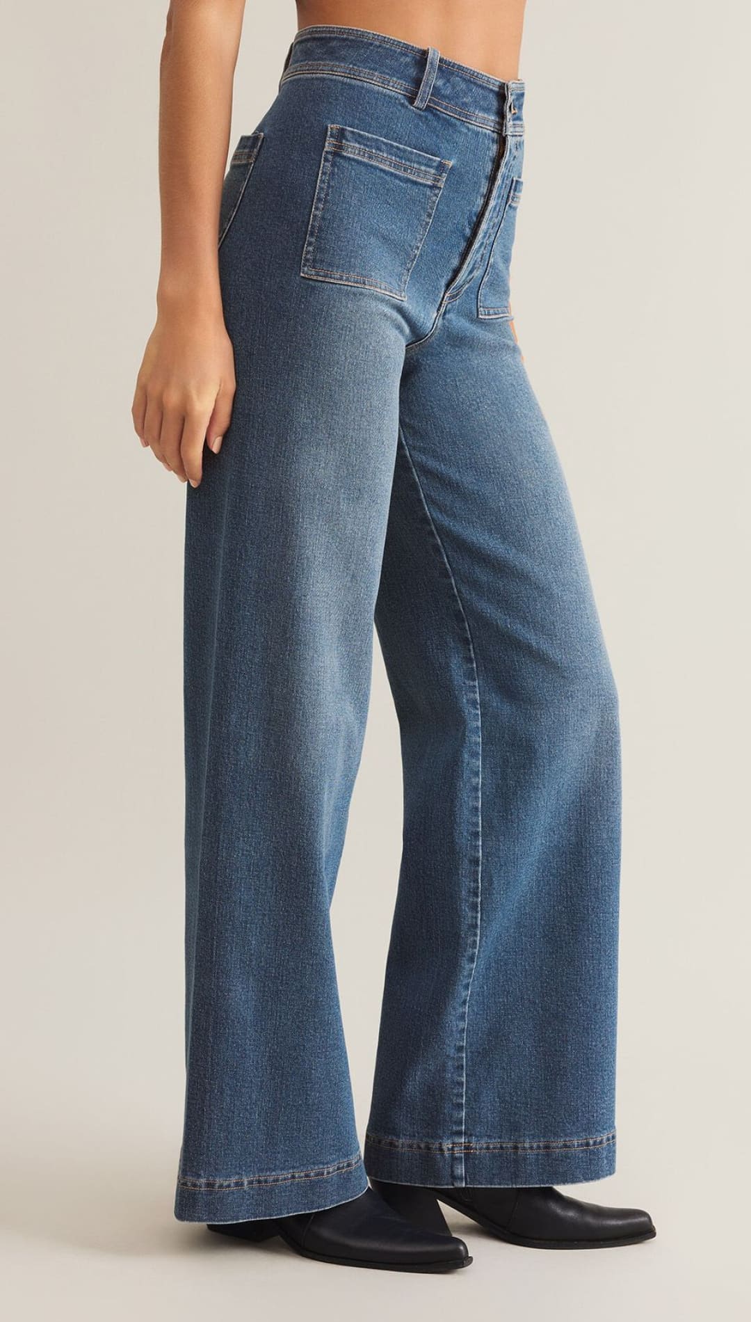 High-waisted, wide-leg blue jeans with front patch pockets and a button fly.