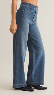 High-waisted, wide-leg blue jeans with front patch pockets and a button fly.