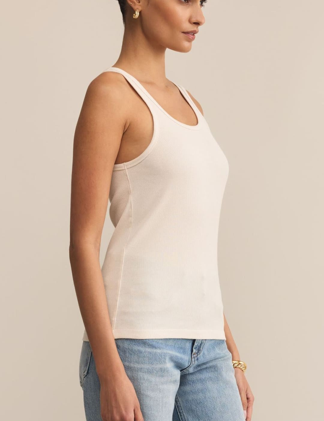 An off-white ribbed tank top with a racerback design.