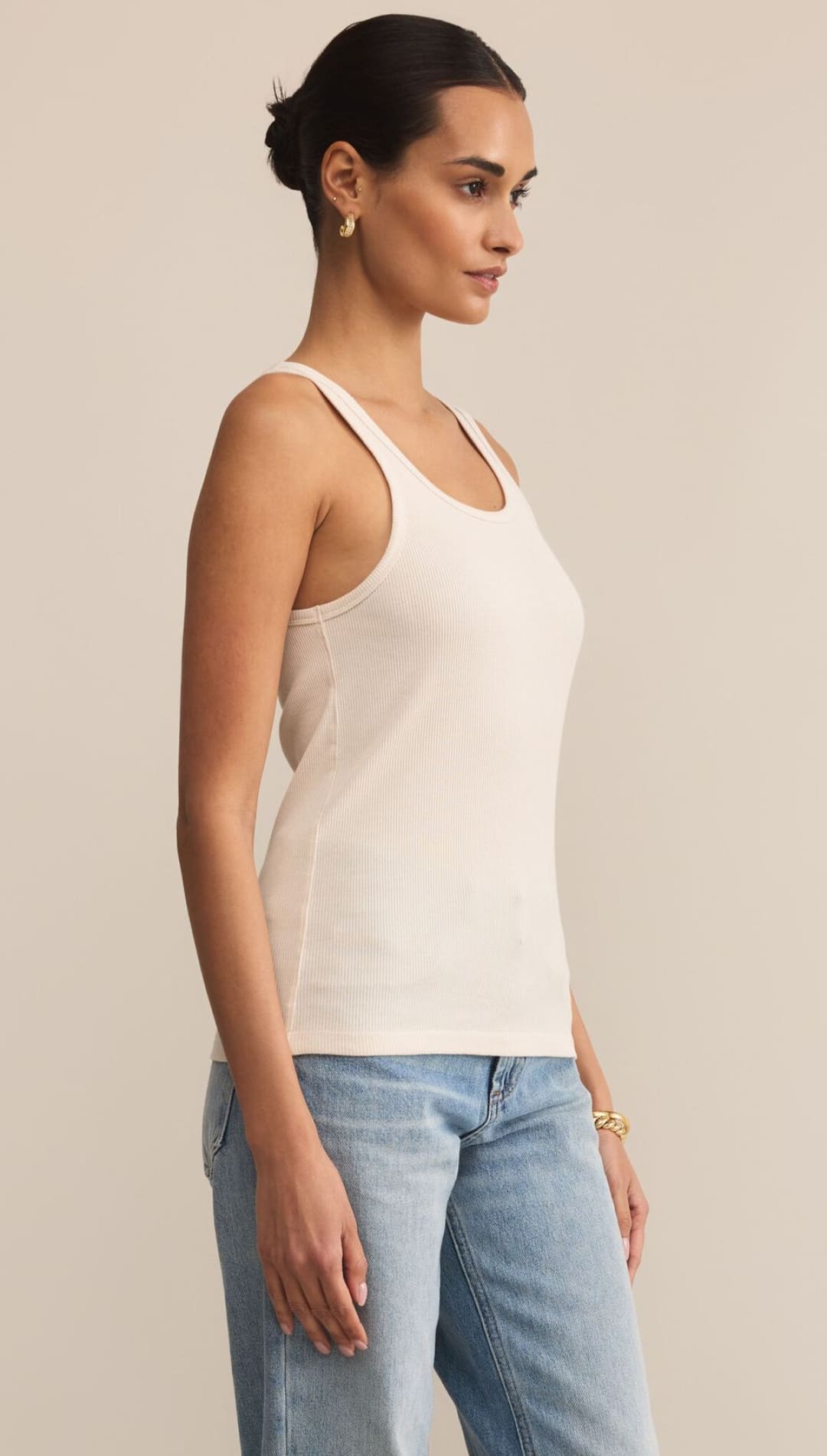 An off-white ribbed tank top with a racerback design.