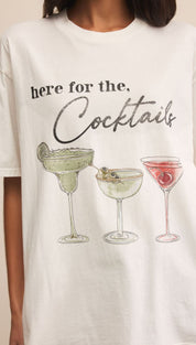 White graphic t-shirt with cocktail illustrations.