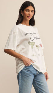 Woman wearing a white graphic t-shirt and blue jeans.