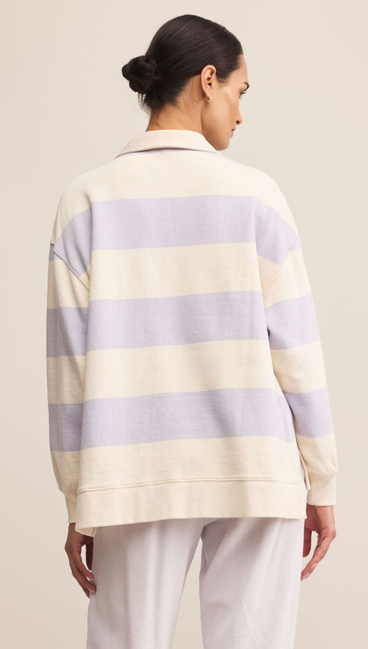 Women’s long-sleeve rugby shirt with cream and lavender horizontal stripes.