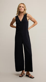 Black jumpsuit with wide-leg design and v-neckline, made of stretchy fabric.