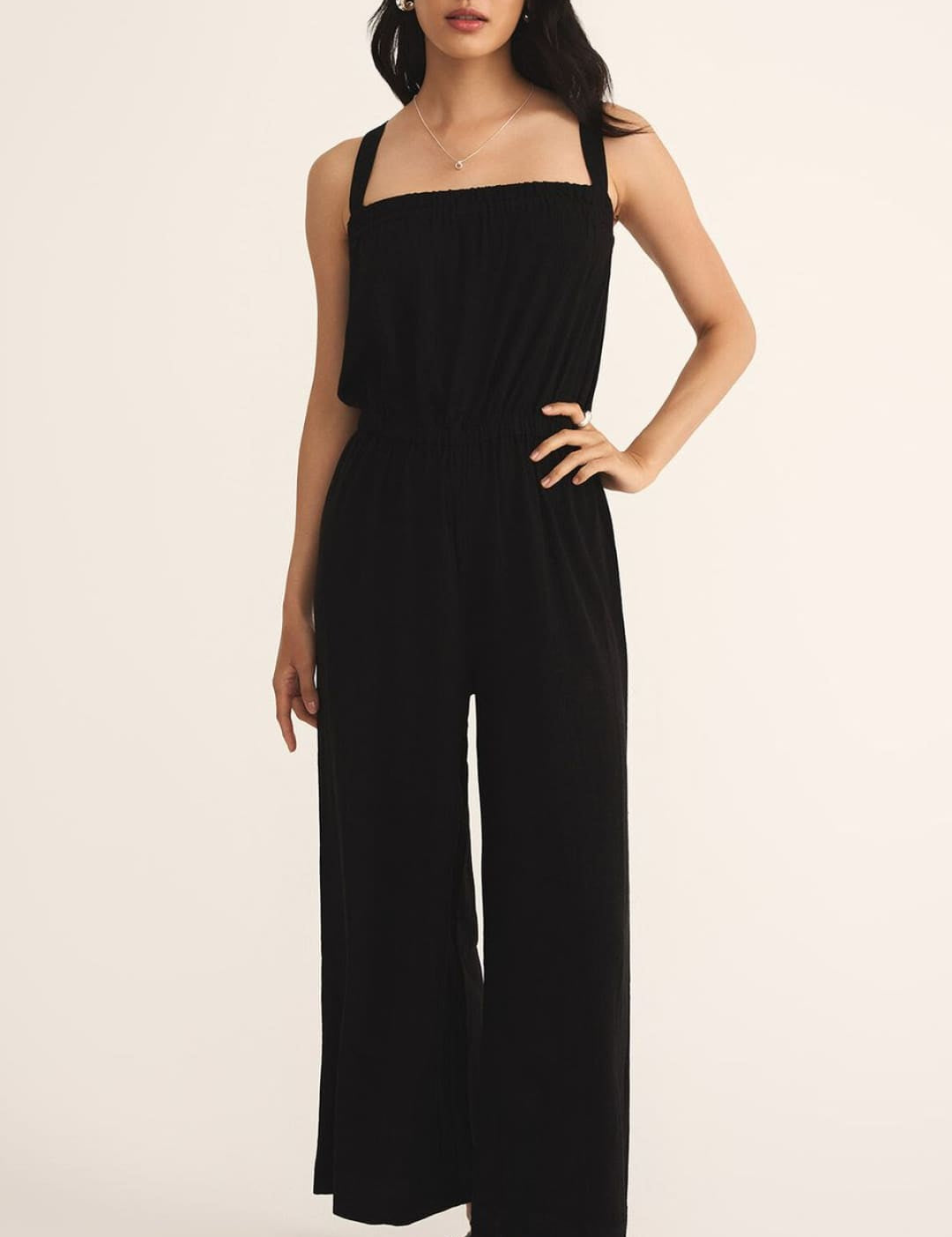 Black sleeveless wide-leg jumpsuit with a square neckline.