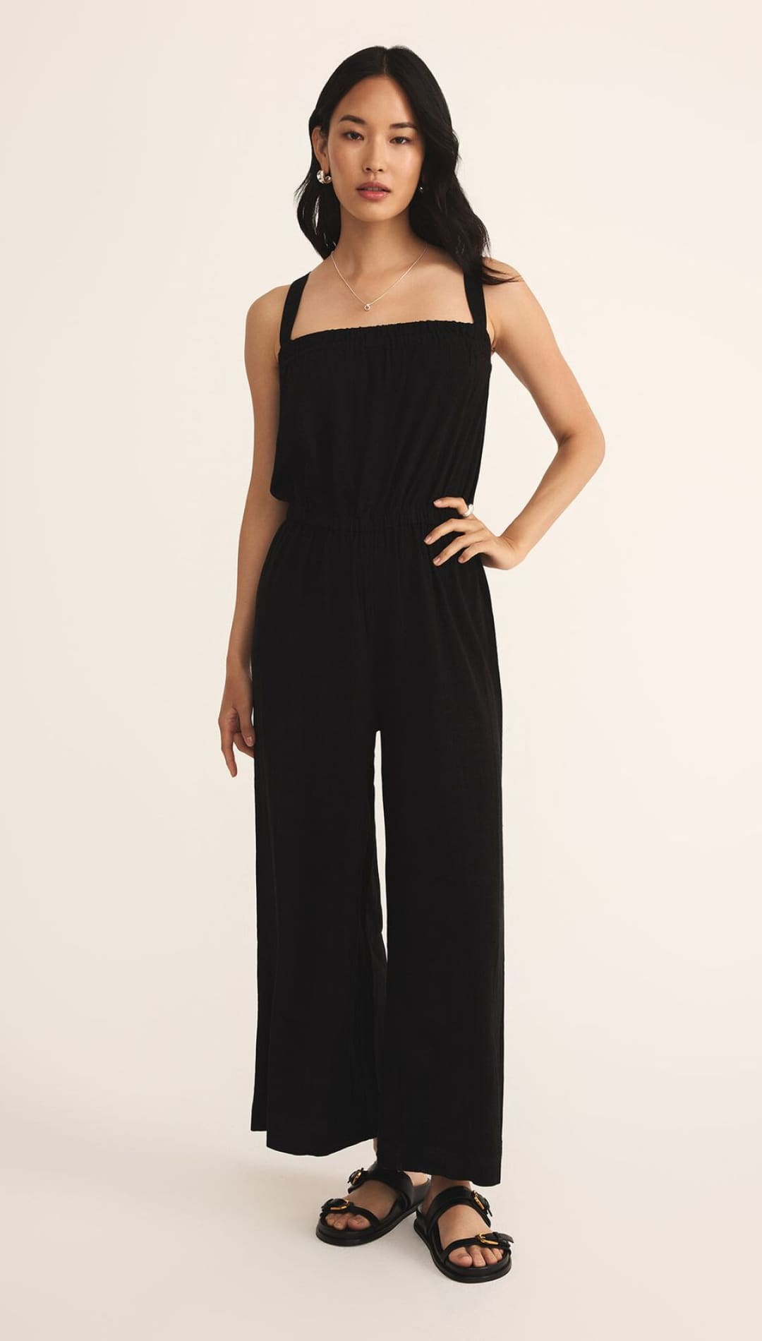 Black sleeveless wide-leg jumpsuit with a square neckline.