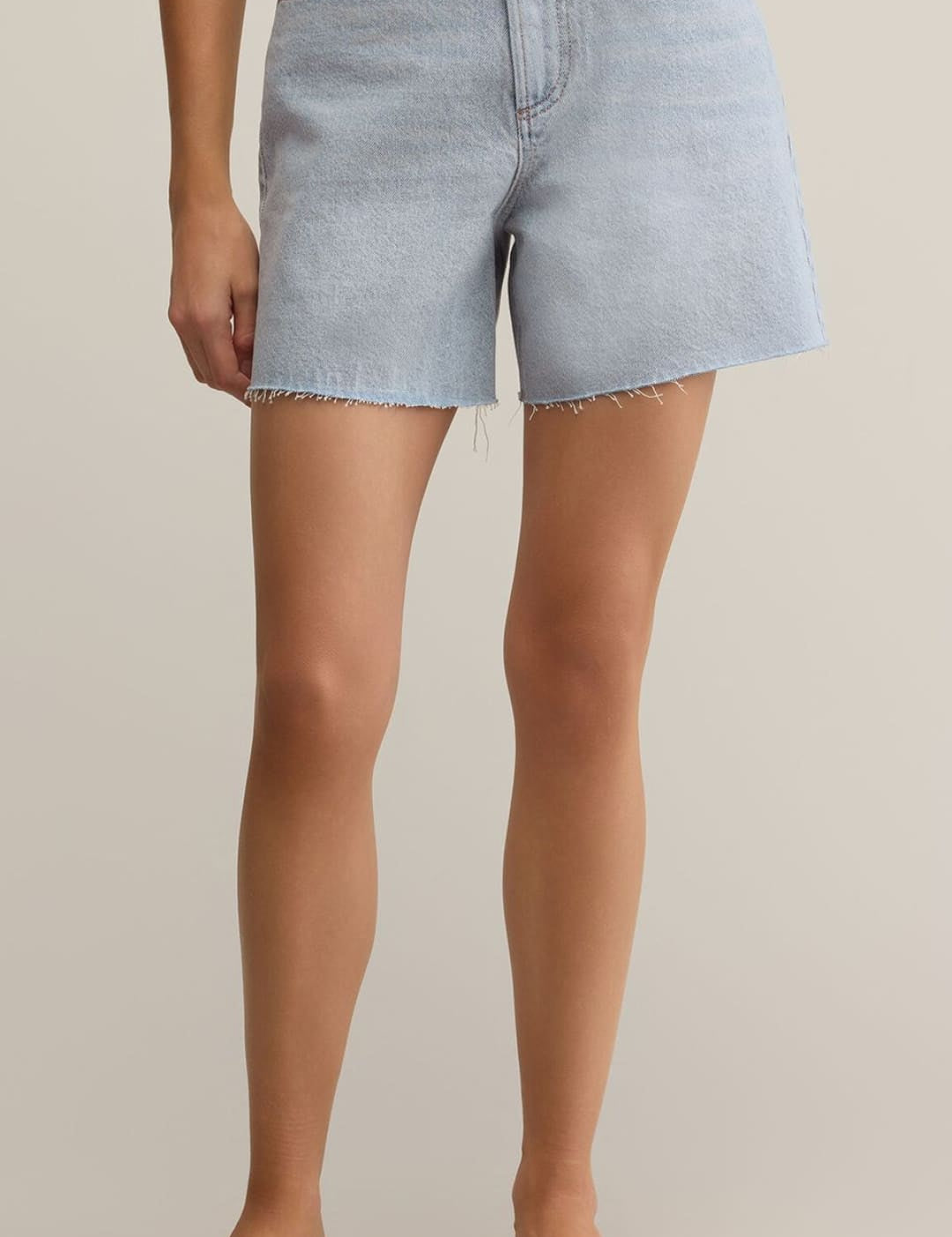 Light blue denim shorts with a raw hem.