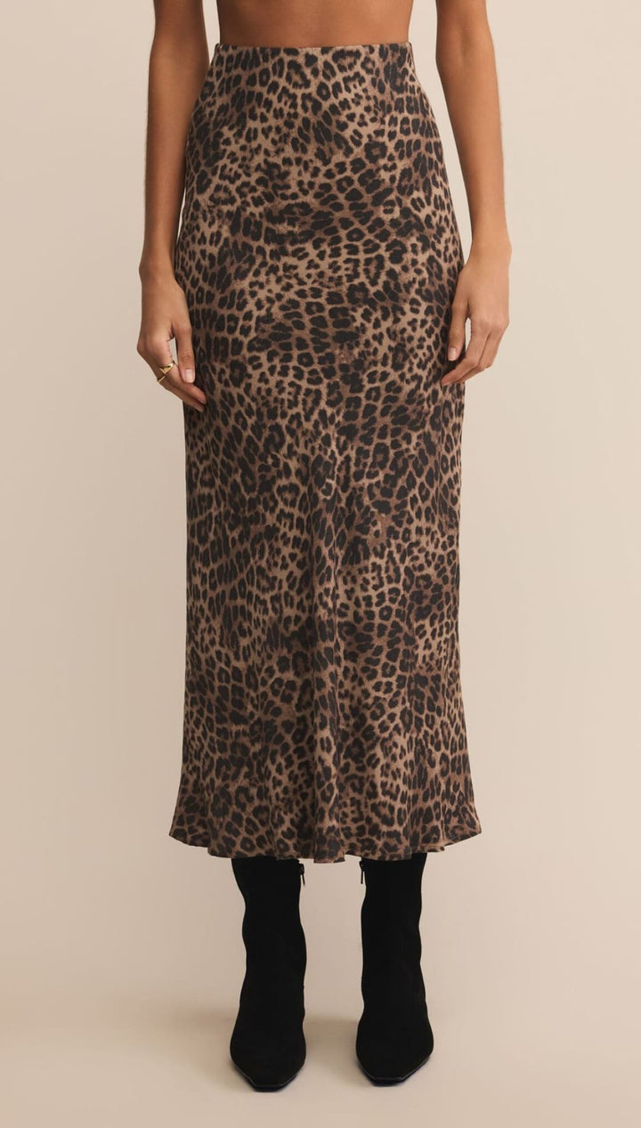 Leopard print midi skirt with high waist and black boots.