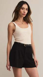 Women’s ribbed knit tank top and black tailored shorts with a belt.