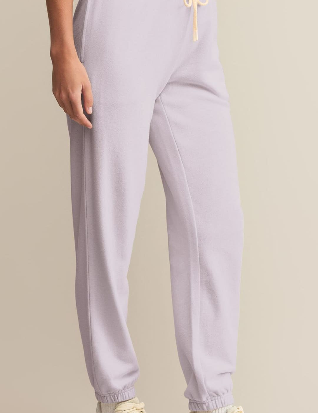 Light purple drawstring sweatpants with elasticated cuffs.