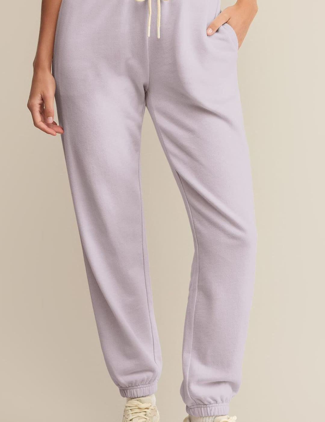 Light purple sweatpants with a cream drawstring.